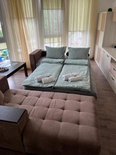 a large bed with two pillows on it in a room at Ultra Lux Apartment Free Underground Secure Parking in Pazardzhik