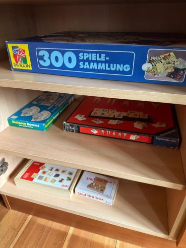 a shelf with a bunch of board games on it at Ski in & Ski out Apartment at Chalet Heinrich in Sonnenalpe Nassfeld