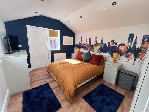 a bedroom with a bed with a city mural on the wall at Waterside Cottage in Preston