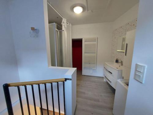 a white bathroom with a sink and a counter at Studio duplex in Beauvais