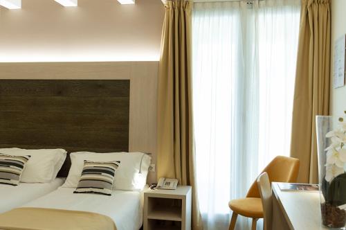 Postel nebo postele na pokoji v ubytování Hotel Alexander