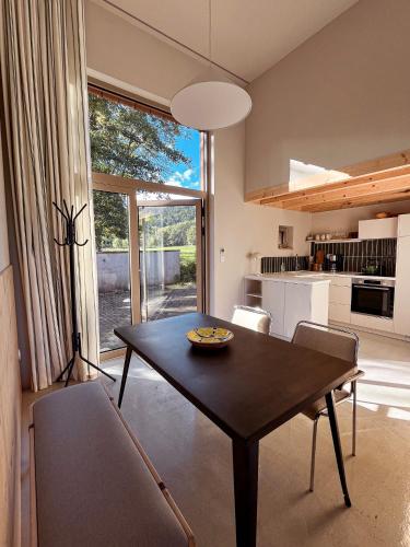 a living room with a table and a kitchen at Grange ALMA in Obernai