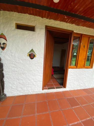 a house with a door open to a patio at CABAÑA LOS NOGALES in San Agustín