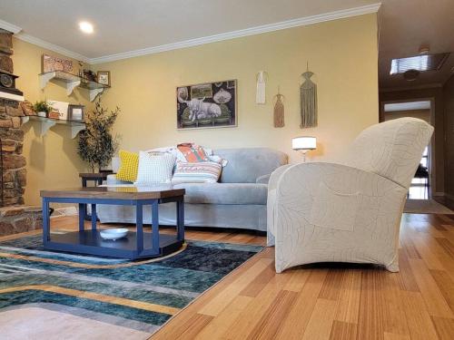 a living room with a couch and a table at My Hideaways Serinity Hill in Hardy