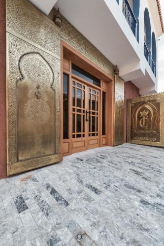an entrance to a building with a wooden door at TAJ CHEFCHAOUEN Luxury Hotel and Spa in Chefchaouen