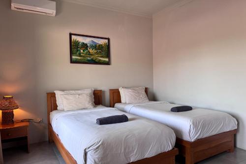 Katil atau katil-katil dalam bilik di Senggigi Cottages Lombok