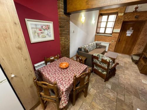 a dining room with a table and a couch at CAN LLORENÇ in Prades