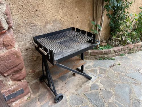 a black barbecue grill sitting on a stone patio at CAN LLORENÇ in Prades
