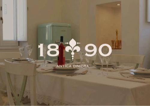a table topped with a table with a white table cloth at Dimora 1890 in Parabita