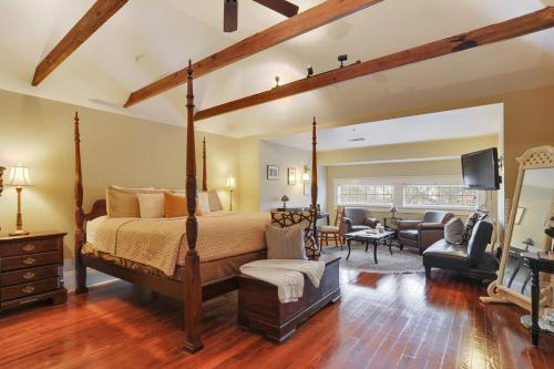 a bedroom with a bed and a living room at Canal Street Inn in New Orleans