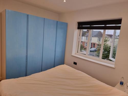 a bedroom with a bed and a window at Wilmer House in Eastleigh