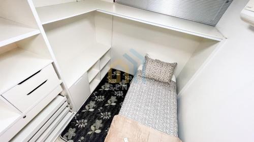 a small room with white shelves and a bed at Eco Summer Tambaú WB Genius Flats in João Pessoa