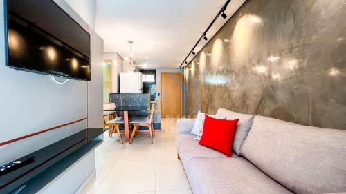 a living room with a couch and a flat screen tv at Eco Summer Tambaú WB Genius Flats in João Pessoa