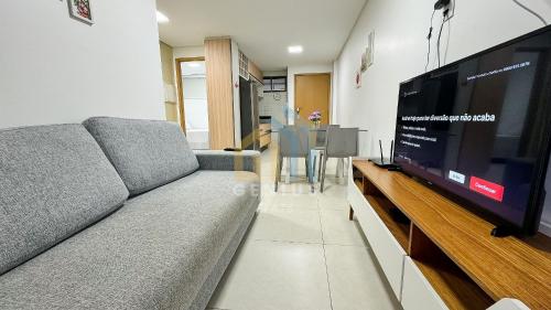 a living room with a couch and a flat screen tv at Eco Summer Tambaú WB Genius Flats in João Pessoa