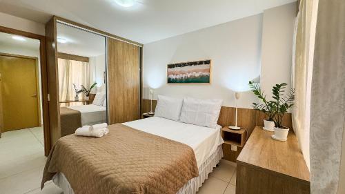 a hotel room with a bed and a bathroom at Eco Summer Tambaú WB Genius Flats in João Pessoa