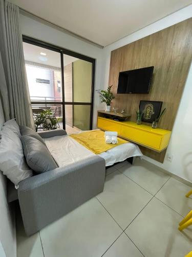 a bedroom with a bed and a tv in a room at Eco Summer Tambaú WB Genius Flats in João Pessoa