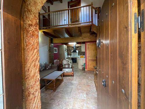 a hallway with a living room and a staircase at CAN LLORENÇ in Prades