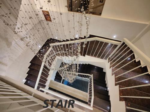 a spiral staircase in a building with a chandelier at Hotel Mandi Heights - Bar, Fine Dining & Banquet Hall in Mandi