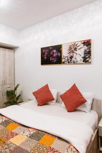 a bedroom with a large bed with two pillows at Zen Studio 2 with balcony in Bucharest