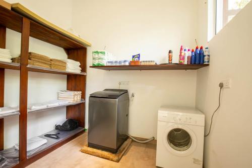 a laundry room with a washing machine in it at Samalanka Boutique Hotel in Habaraduwa