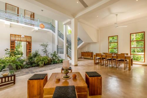 an open living room with a table and chairs at Samalanka Boutique Hotel in Habaraduwa