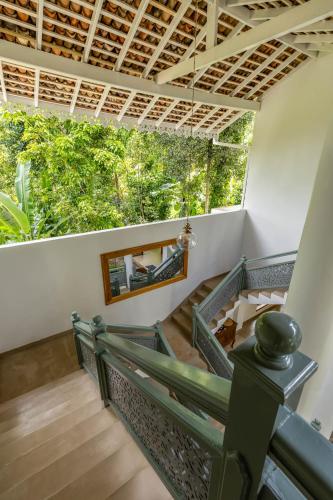 a staircase in a house with a large window at Samalanka Boutique Hotel in Habaraduwa