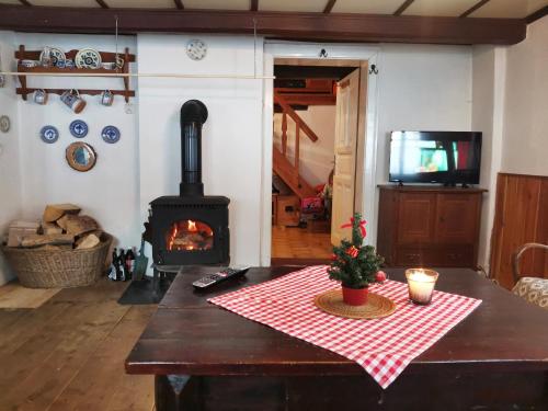 a living room with a table and a fireplace at Chalupa u Matucha in Jablonec nad Nisou