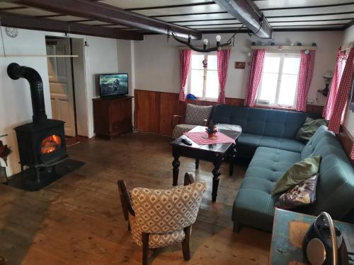 a living room with a couch and a fireplace at Chalupa u Matucha in Jablonec nad Nisou