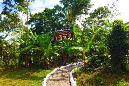 a sign in the middle of a banana plantation at Logan's Paradise Vacation Home in Tena