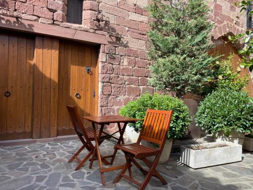 two chairs and a table on a patio at CAN LLORENÇ in Prades