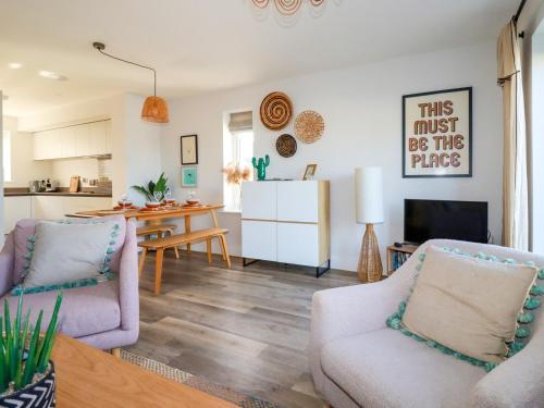 a living room with two chairs and a table at The Waves in Newquay