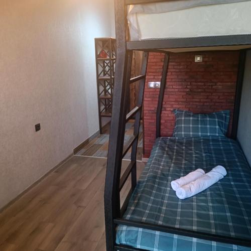 a room with two bunk beds with a green mattress at Hotel Riverside Inn in Martuni