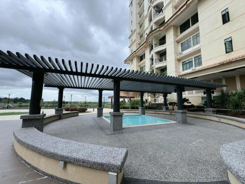 a pavilion with a pool in front of a building at Kuching Cozy Comfort 03 - Riverine Diamond Kuching 5 Pax in Kuching
