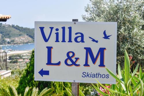 a sign for a villa lem sign at Apartments Villa L&M Skiathos in Skiathos Town