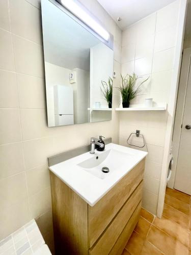 a bathroom with a sink and a mirror at LA MER BLEUE, Boutique Apartament with free parking, full equipped in Fenals Beach in Lloret de Mar