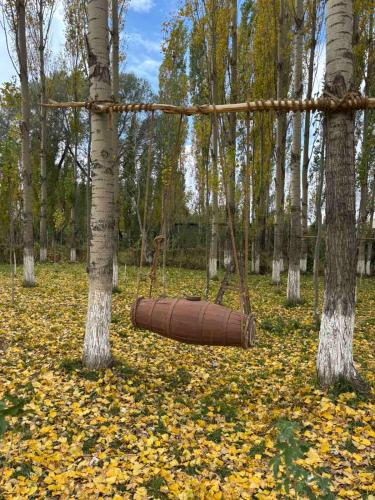 a brown swing in a forest with trees at Zovaber hangsti goti in Sevan