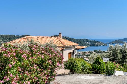 a house with a view of the water at Apartments Villa L&M Skiathos in Skiathos Town