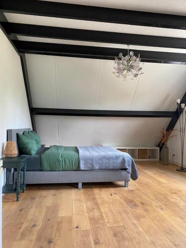 a bedroom with a bed in a room with a ceiling at Toenders in Wintelre