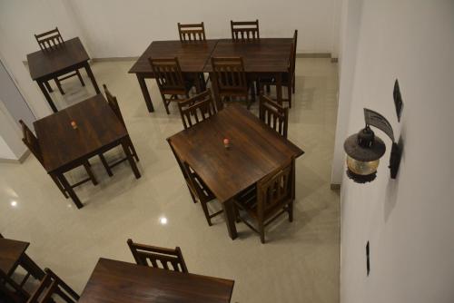 an overhead view of a dining room with wooden tables and chairs at Sea View Tourist Inn in Tangalle