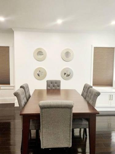 a dining room with a wooden table and chairs at Comfort and Location! in Medford