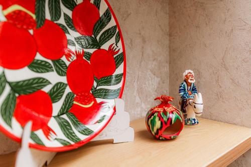 a red and white vase on a shelf next to a mirror at BEX SUENO HOTEL in Samarkand