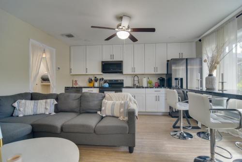 a living room with a couch and a kitchen at 13 Mi to Busch Gardens Tampa Gem with Grill and Yard in Tampa