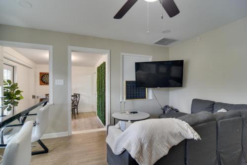 a living room with a gray couch and a flat screen tv at 13 Mi to Busch Gardens Tampa Gem with Grill and Yard in Tampa