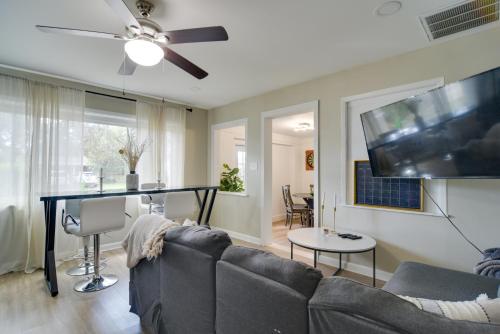 a living room with a couch and a flat screen tv at 13 Mi to Busch Gardens Tampa Gem with Grill and Yard in Tampa