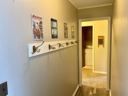 a hallway with a wall with bikes on it at Secluded Au Sable River Home in Grayling