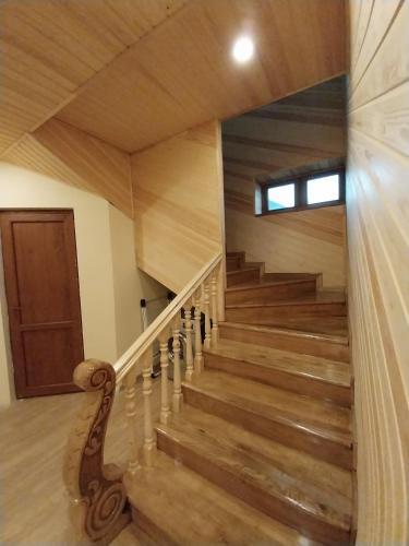 a staircase in a house with wooden floors at The River View Villa الحلال Halal Concept in Quba