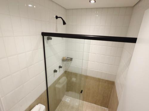 a shower with a glass door in a bathroom at Apê Brás - Shopping Plaza Polo in Sao Paulo