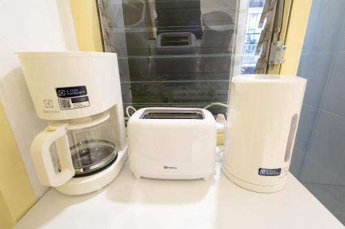 two coffeemakers and a toaster sitting on a counter at Cozy & Affordable apartment in Chiang Mai in Chiang Mai