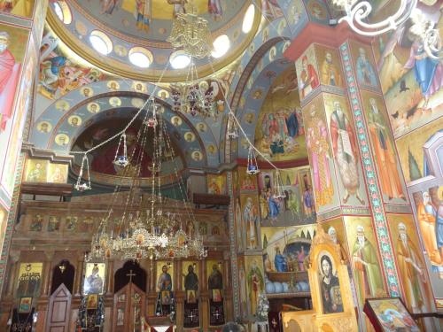a church with paintings on the ceilings and a chandelier at Sea of Galilee - Genghis Khan in The Golan in Giv'at Yo'av