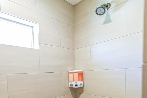 a shower in a bathroom with a window at Red Desert Villa in Hurricane